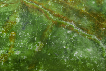 Green natural marble with brown veins in cracks, texture for ceramic tiles and floor tiles