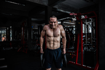 Portrait of asian man big muscle at the gym,Thailand people,Workout for good healthy,Body weight training,Fitness at the gym concept,Prank to abdominal muscles,Lift up heavy steel plate