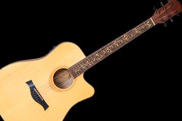 Acoustic guitar made of wood on a black background