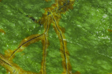 Green natural marble with brown veins in cracks, texture for ceramic tiles and floor tiles