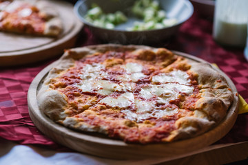 Buffet table with pizza on wooden tray