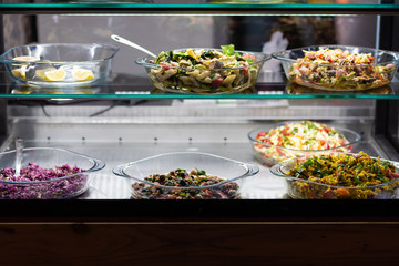 Variety of salad in restaurant shelf 