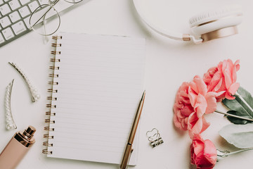 Office desk with computer and rose flowers
