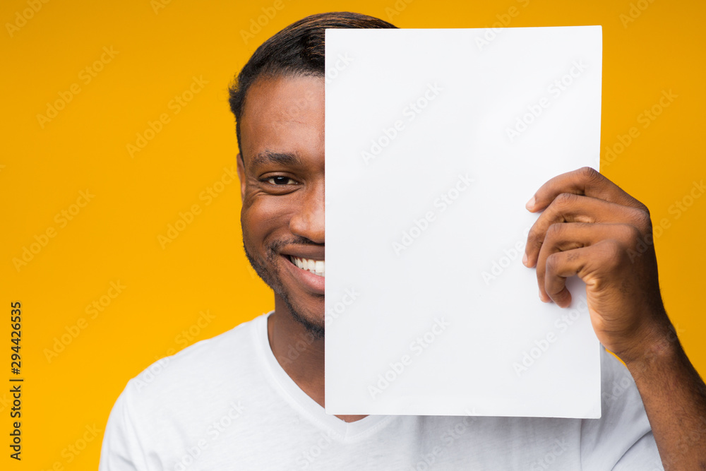 Poster Man Covering Half Of Face With Paper Sheet In Studio