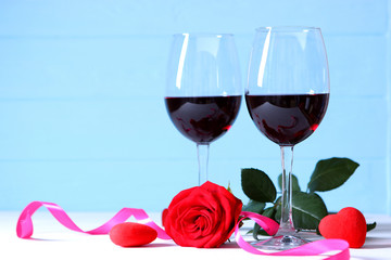 red wine and roses on the table. Valentine's day background. A gala dinner for two.