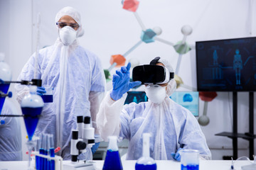 Female scientist working with virtual reality goggles