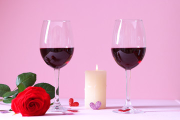 red wine and roses on the table. Valentine's day background. A gala dinner for two.