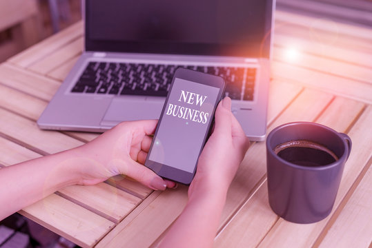 Writing note showing New Business. Business concept for the activity of buying and selling goods and services woman with laptop smartphone and office supplies technology