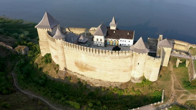 Aerial view of old castle near the River. Hotyn Castle in Ukraine. Eastern Europe. Tracking from right to left. Top view.