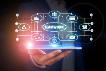 Naklejka premium Word writing text Teamwork. Business photo showcasing combined action of group especially when effective and efficient Male human wear formal work suit presenting presentation using smart device