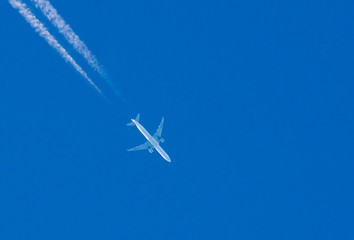 Huge transport turbine planes high in the blue sky.