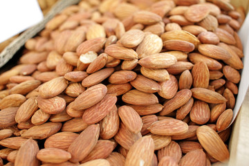 Almonds. Overhead view of raw organic almonds as a background. Peeled almond nuts. Healthy food concept. Vegetarian. Nuts pattern