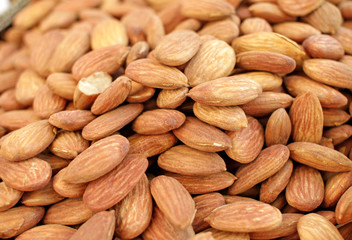 Almonds. Overhead view of raw organic almonds as a background. Peeled almond nuts. Healthy food concept. Vegetarian. Nuts pattern