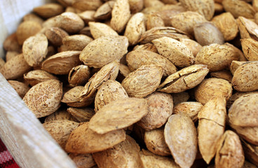 Almonds. Raw organic almonds as a background. Almond nuts with shells. Healthy food concept. Vegetarian. Nuts pattern
