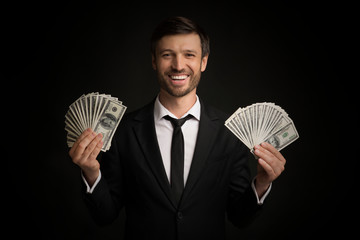 Happy Businessman Holding Money In Hands Standing In Studio
