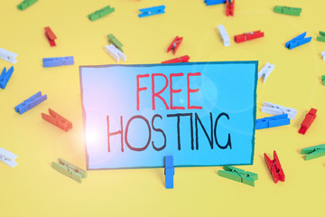 Text sign showing Free Hosting. Business photo showcasing business of providing storage space and access for websites Colored clothespin papers empty reminder yellow floor background office