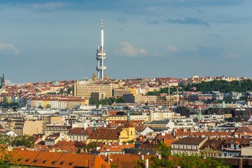Aerial view of citycape of old town of Prague, with a lot of  rooftops, churches, and the landmark of Television Tower. view from the Letna park.