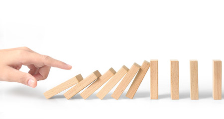 Hand stopping the Domino effect stopped by unique