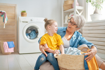 grandma and child are doing laundry