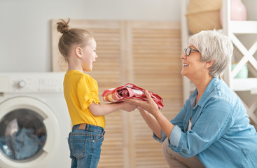 grandma and child are doing laundry