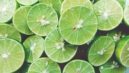 Lime Background. Close up shot of limes. Selective Focus of sliced lime.