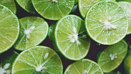 Lime Background. Close up shot of limes. Selective Focus of sliced lime.
