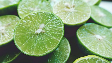 Lime Background. Close up shot of limes. Selective Focus of sliced lime.