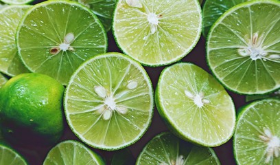 Lime Background. Close up shot of limes. Selective Focus of sliced lime.