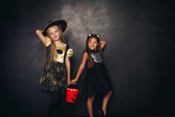 Pretty girls with full candy collector on Halloween