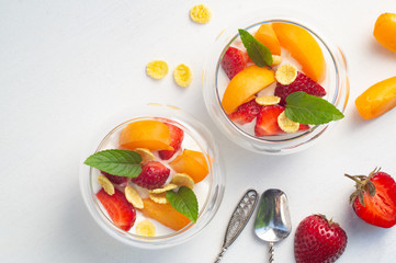 Vitamin dessert of fresh strawberries, apricots and cornflakes with yogurt