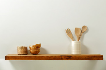 Wooden kitchen shelf of free space for your decoration and gray wall space 