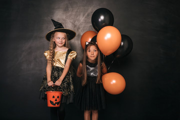 Surprised girls with balloons and candy collector