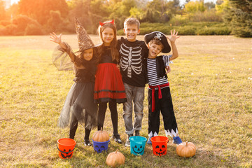 Cheerful friends celebrating Halloween in park
