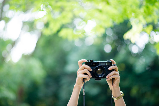 Photographer and camera lover Black camera and natural green background