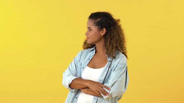 Young African American woman feeling sad and about to cry isolated on studio yellow background