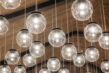 Lamps hanging from the ceiling on the wooden background