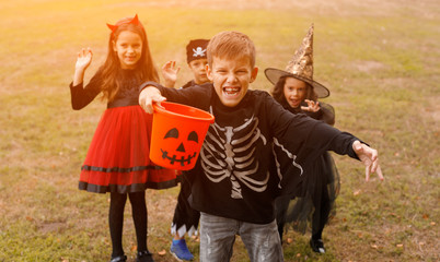 Little skeleton trick or treating with friends