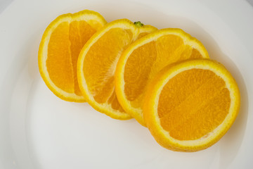 Slice of orange on a white plate.