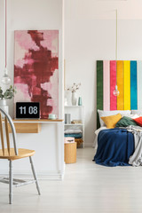 Open space bedroom and home office interior with bed and desk