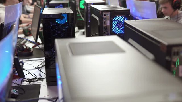 Team of professional e-sportsmen playing competitive video games at the cyber games tournament