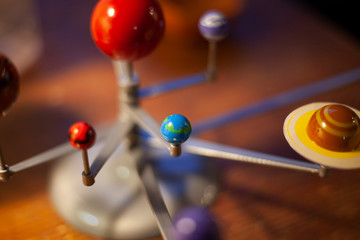 Solar system in miniature. Layout of our system. Star and planets around. Toy planet in space. The...