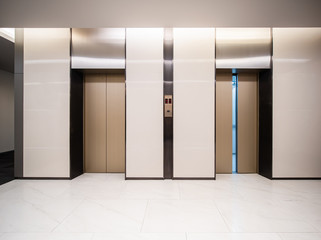 Modern steel elevator cabins in a business lobby or Hotel, Store, interior, office,perspective wide angle. Three elevators in hotel lobby