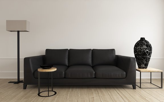 Comfortable modern black leather sofa with vase