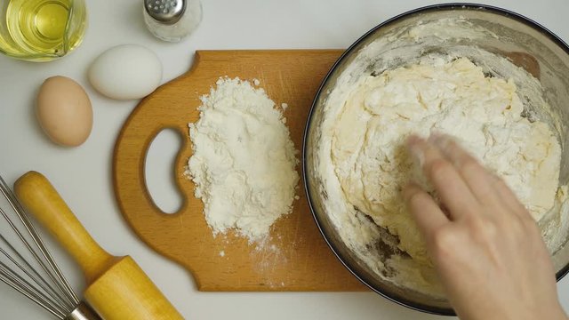 Video of woman kneads dough in the kitchen