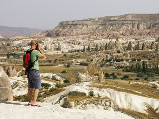 Man taking photographs of the fairy chimney landscape in Cappadocia