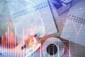 Multi exposure of woman's hands making notes with forex graph hologram. Concept of technical analysis.