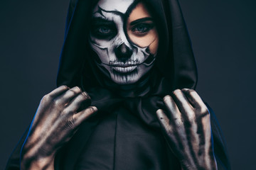 Mysterious woman adjusting black hood
