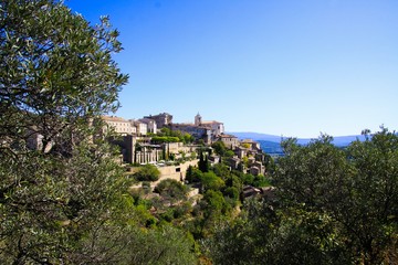 Fototapeta na wymiar Panoramic view on medieval old french village on hill top against blue sky - Gordes, Provence, France