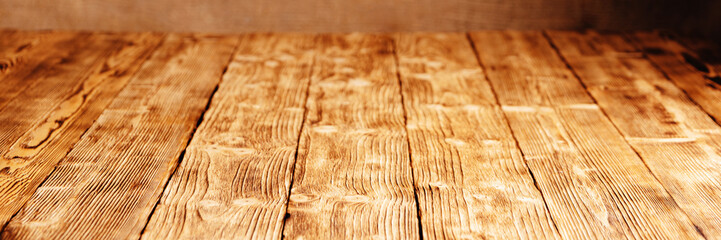 Wide, panoramic background of wooden boards shot in perspective at an angle.