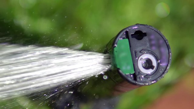 Close view of a sprinkler wathering the grass, lawn